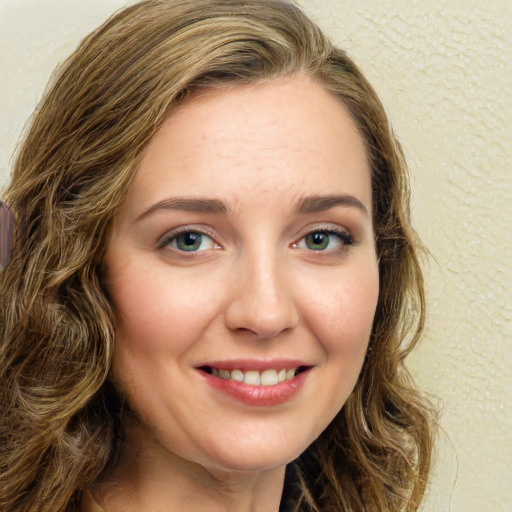 Joyful white young-adult female with long  brown hair and green eyes