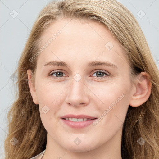 Joyful white young-adult female with long  brown hair and blue eyes