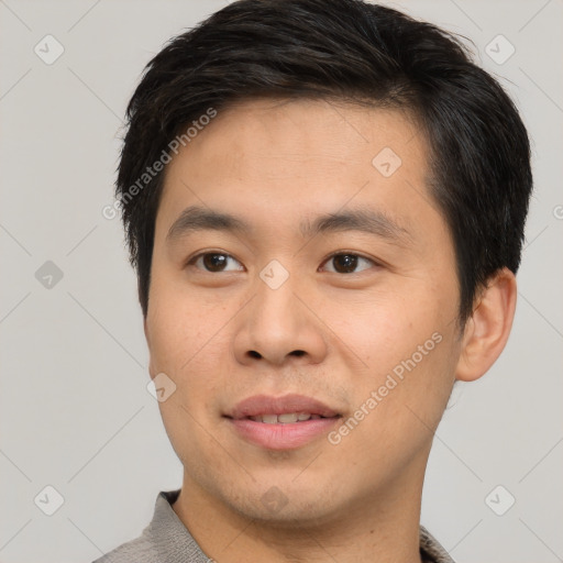 Joyful asian young-adult male with short  brown hair and brown eyes