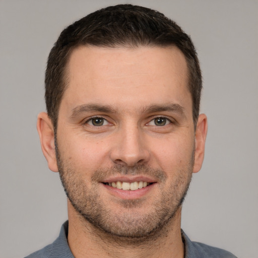 Joyful white young-adult male with short  brown hair and brown eyes