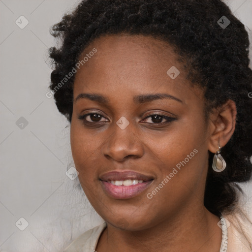 Joyful black young-adult female with long  black hair and brown eyes