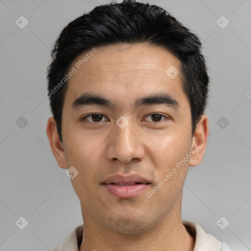 Joyful asian young-adult male with short  black hair and brown eyes