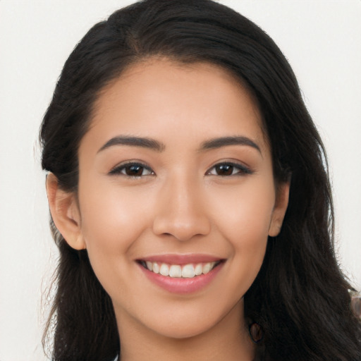 Joyful latino young-adult female with long  brown hair and brown eyes