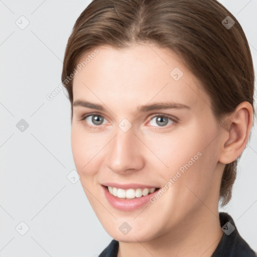 Joyful white young-adult female with medium  brown hair and grey eyes