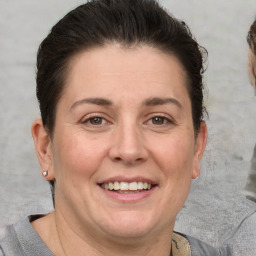 Joyful white adult female with short  brown hair and brown eyes