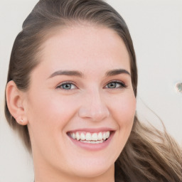 Joyful white young-adult female with long  brown hair and blue eyes