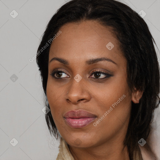 Joyful black young-adult female with long  brown hair and brown eyes