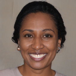 Joyful black adult female with short  brown hair and brown eyes