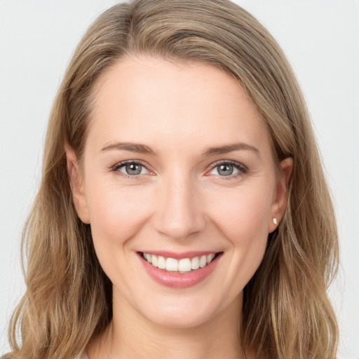 Joyful white young-adult female with long  brown hair and grey eyes