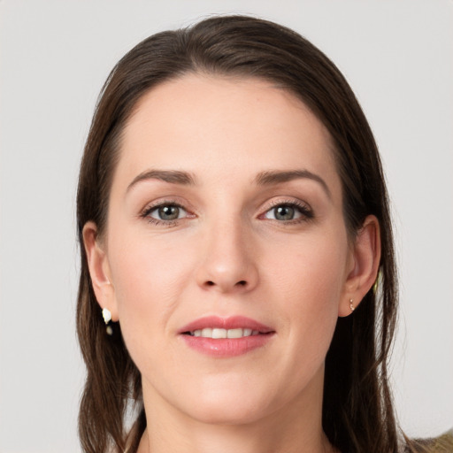 Joyful white young-adult female with long  brown hair and grey eyes