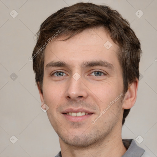 Joyful white young-adult male with short  brown hair and grey eyes