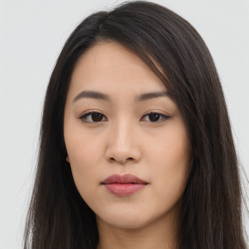 Joyful asian young-adult female with long  brown hair and brown eyes