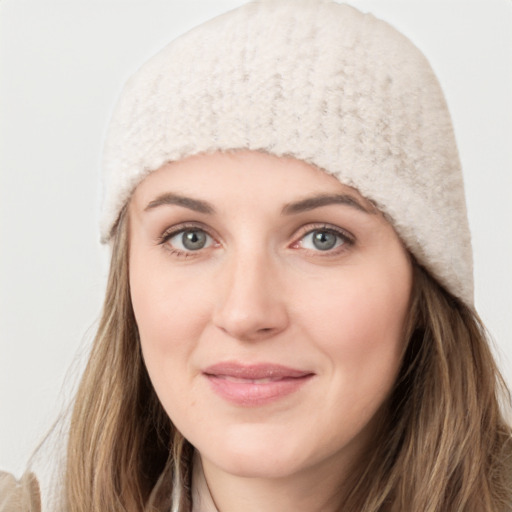 Joyful white young-adult female with long  brown hair and grey eyes