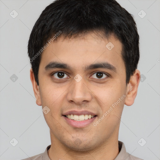 Joyful latino young-adult male with short  brown hair and brown eyes