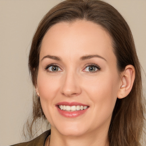 Joyful white young-adult female with long  brown hair and brown eyes