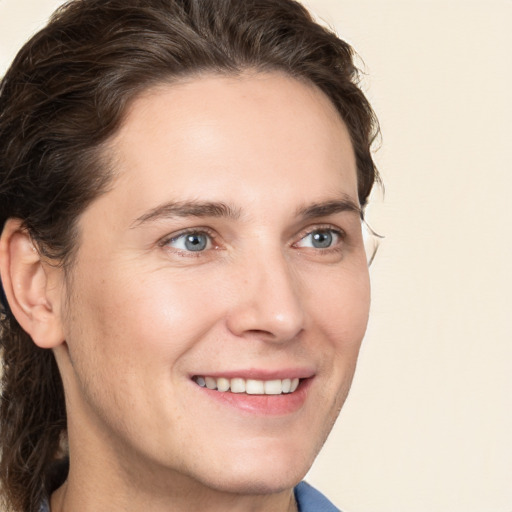 Joyful white young-adult male with medium  brown hair and brown eyes