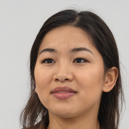 Joyful asian adult female with long  brown hair and brown eyes