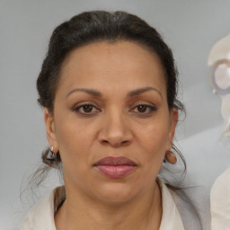 Joyful black adult female with medium  brown hair and brown eyes