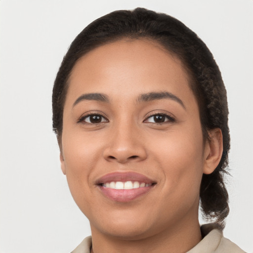 Joyful latino young-adult female with short  brown hair and brown eyes