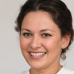 Joyful white adult female with medium  brown hair and brown eyes