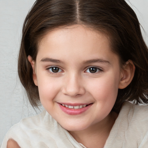 Joyful white child female with medium  brown hair and brown eyes