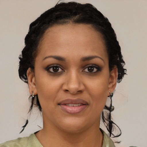 Joyful black young-adult female with short  black hair and brown eyes