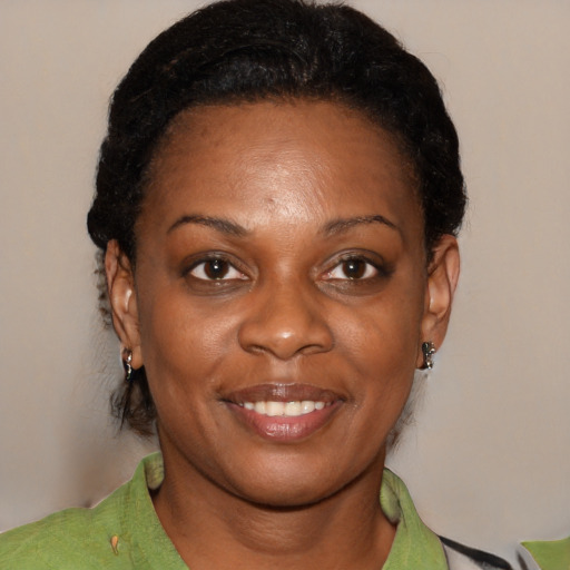 Joyful black adult female with short  black hair and brown eyes