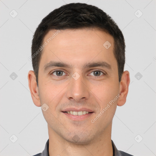 Joyful white young-adult male with short  brown hair and brown eyes