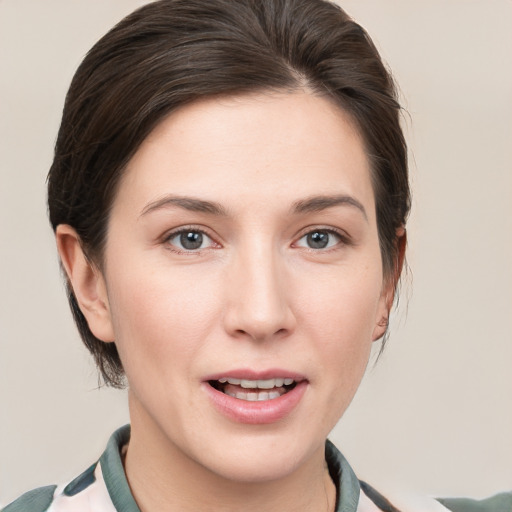 Joyful white young-adult female with medium  brown hair and grey eyes