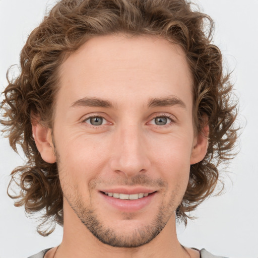 Joyful white young-adult male with medium  brown hair and brown eyes