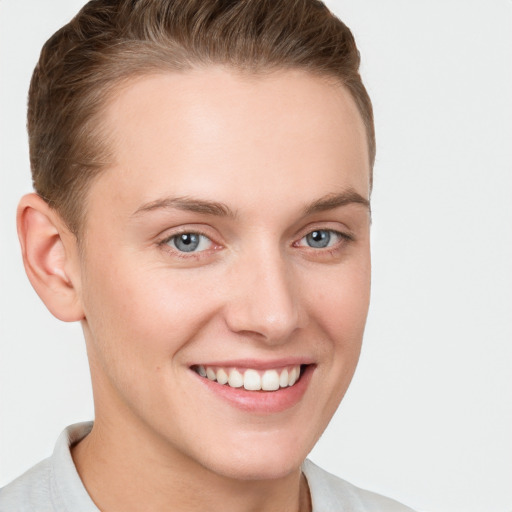 Joyful white young-adult female with short  brown hair and grey eyes