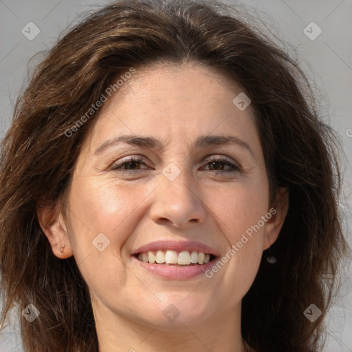 Joyful white adult female with long  brown hair and brown eyes