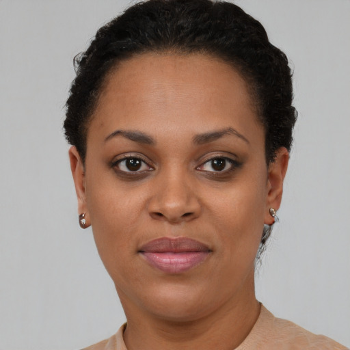 Joyful black young-adult female with short  brown hair and brown eyes