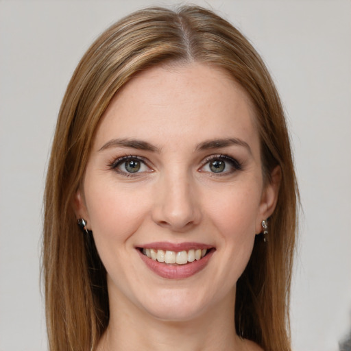 Joyful white young-adult female with long  brown hair and green eyes