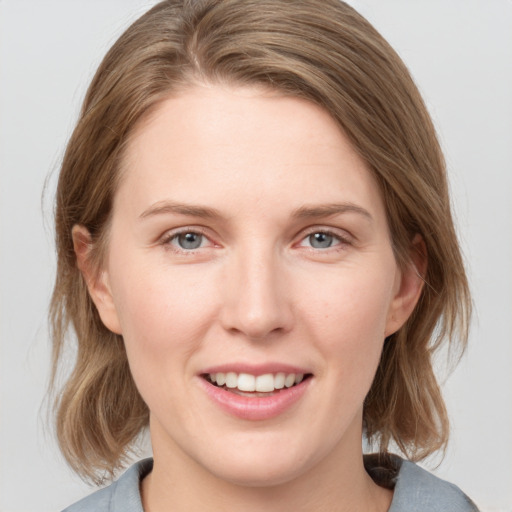 Joyful white young-adult female with medium  brown hair and blue eyes