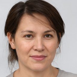 Joyful white adult female with medium  brown hair and brown eyes