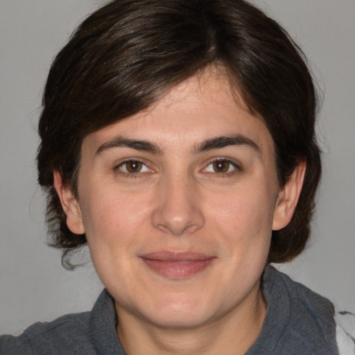 Joyful white adult female with medium  brown hair and brown eyes