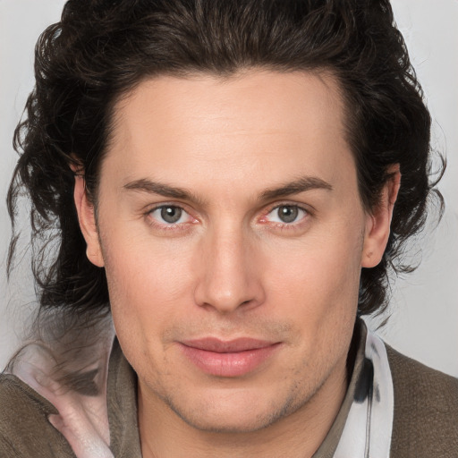 Joyful white young-adult male with medium  brown hair and brown eyes