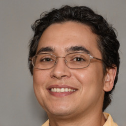 Joyful white adult male with medium  brown hair and brown eyes