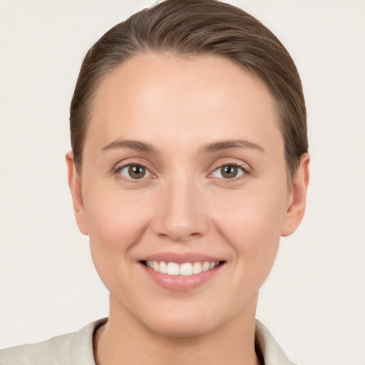 Joyful white young-adult female with medium  brown hair and brown eyes