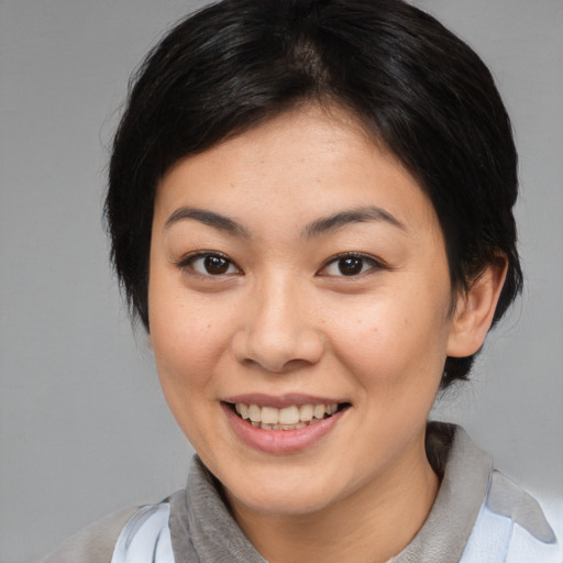 Joyful asian young-adult female with medium  brown hair and brown eyes