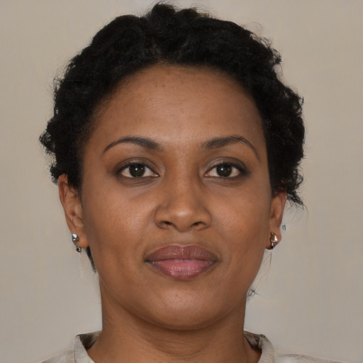 Joyful black adult female with short  brown hair and brown eyes