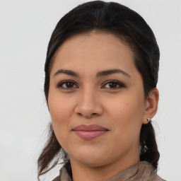 Joyful latino young-adult female with medium  brown hair and brown eyes