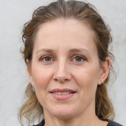 Joyful white adult female with medium  brown hair and grey eyes