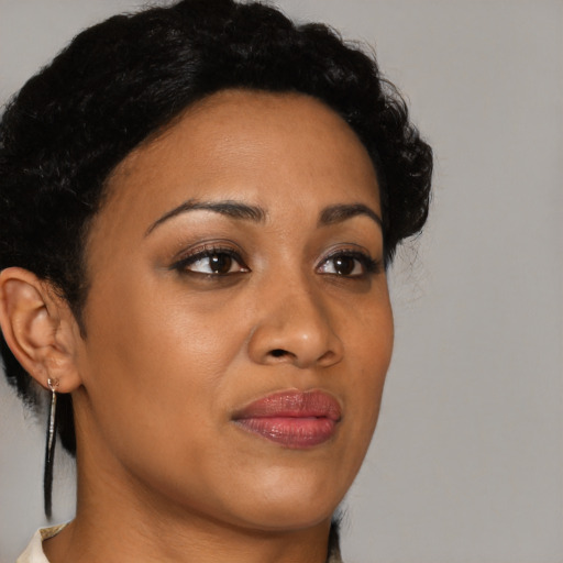 Joyful black young-adult female with medium  brown hair and brown eyes