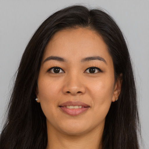 Joyful asian young-adult female with long  brown hair and brown eyes