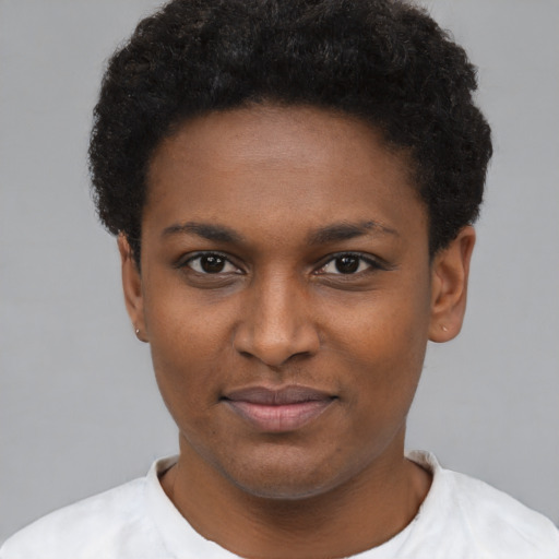 Joyful black young-adult female with short  black hair and brown eyes
