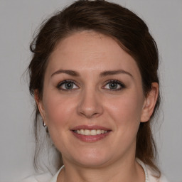 Joyful white young-adult female with medium  brown hair and brown eyes