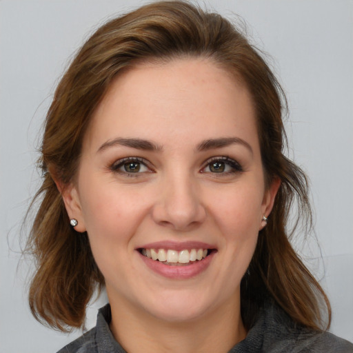 Joyful white young-adult female with medium  brown hair and blue eyes