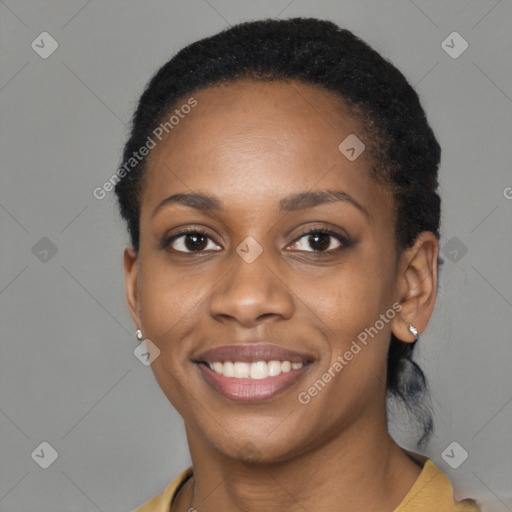 Joyful black young-adult female with short  black hair and brown eyes